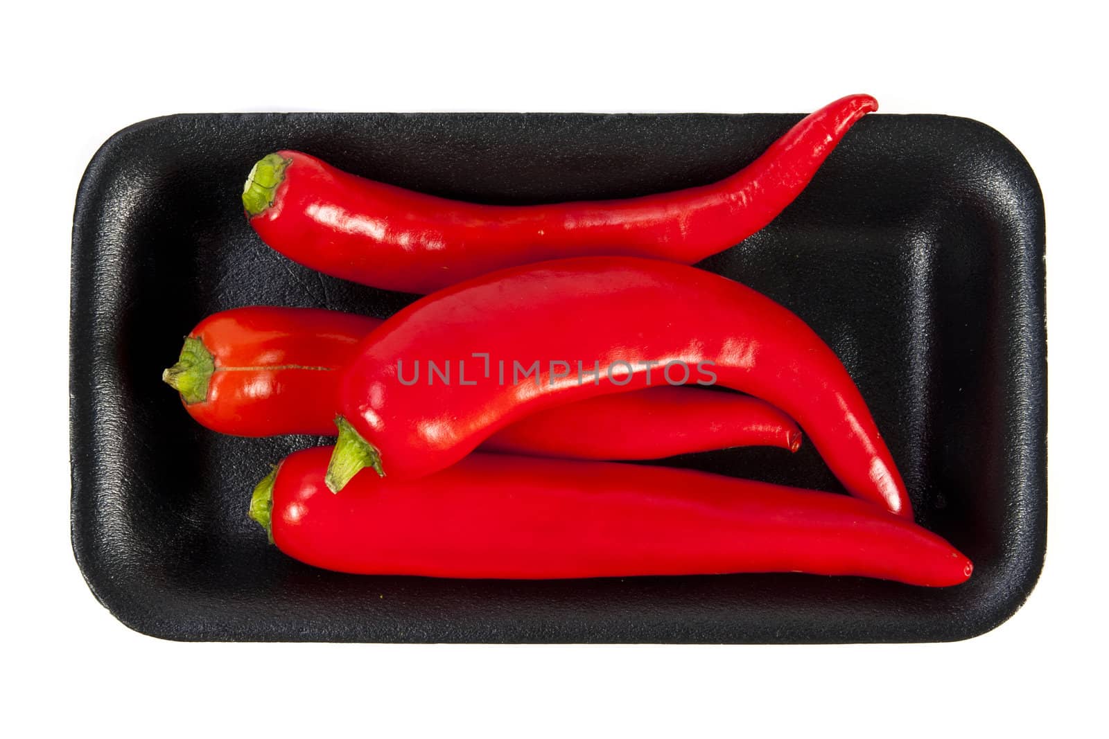 Fresh red hot pepper with black plate on a white background