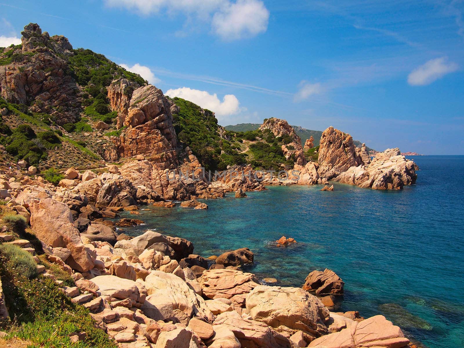 Typical clear water and red rocks of the coast of Sardinia, Italy.