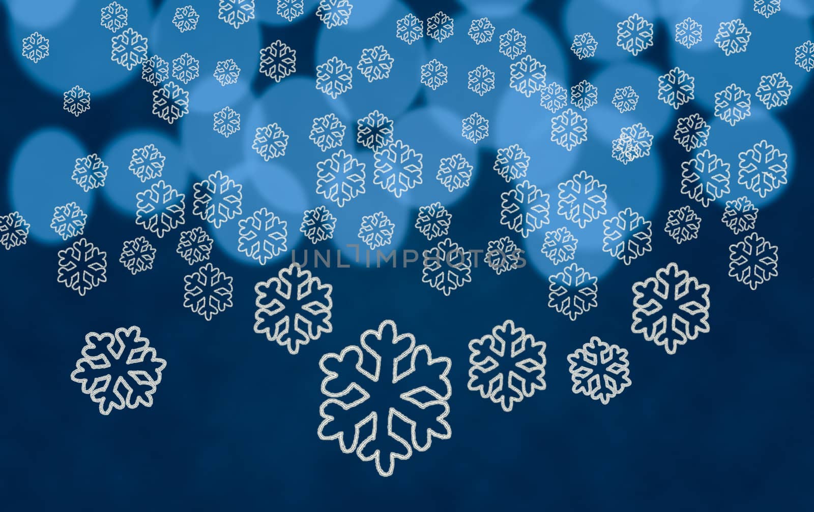 White snowflake shapes dropping in front of blue out of focus christmas tree lights
