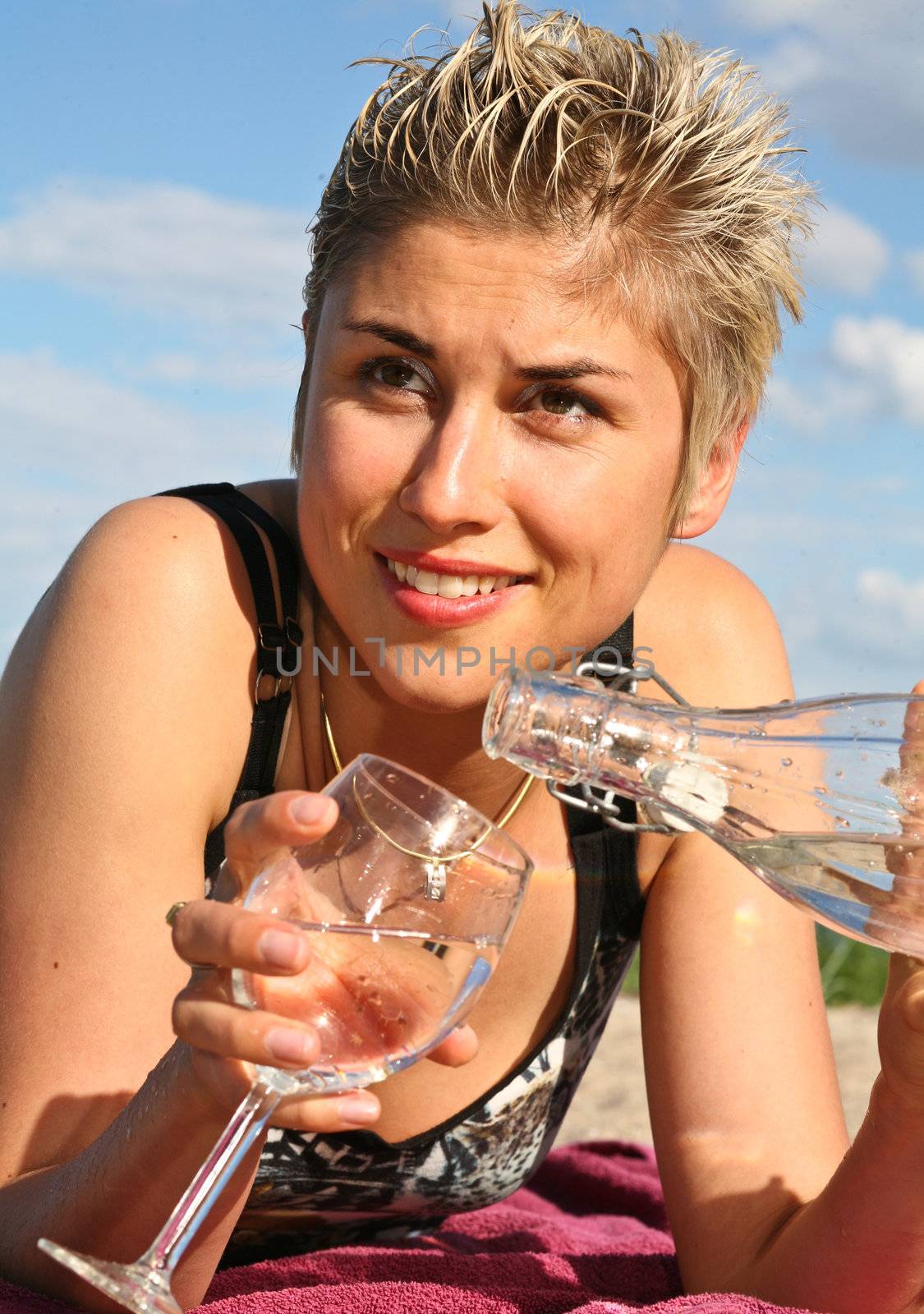 Cute blond girl playing with water in the summer in Denmark