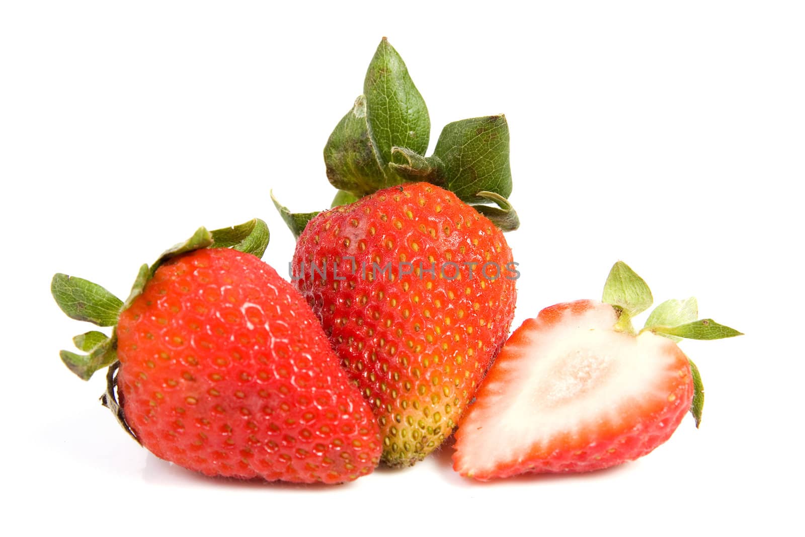 Image of two isolated strawberries, one of them is sliced in half.