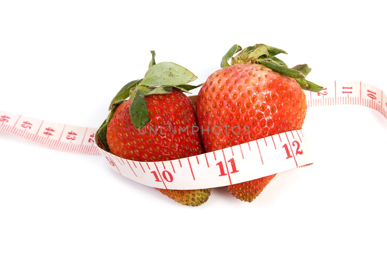 Image of two isolated strawberries with tape measure
