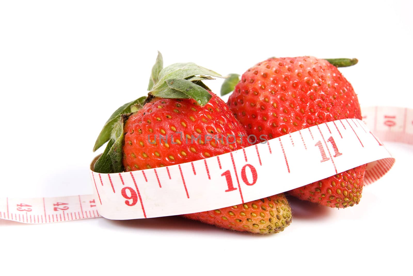 Image of two isolated strawberries with tape measure