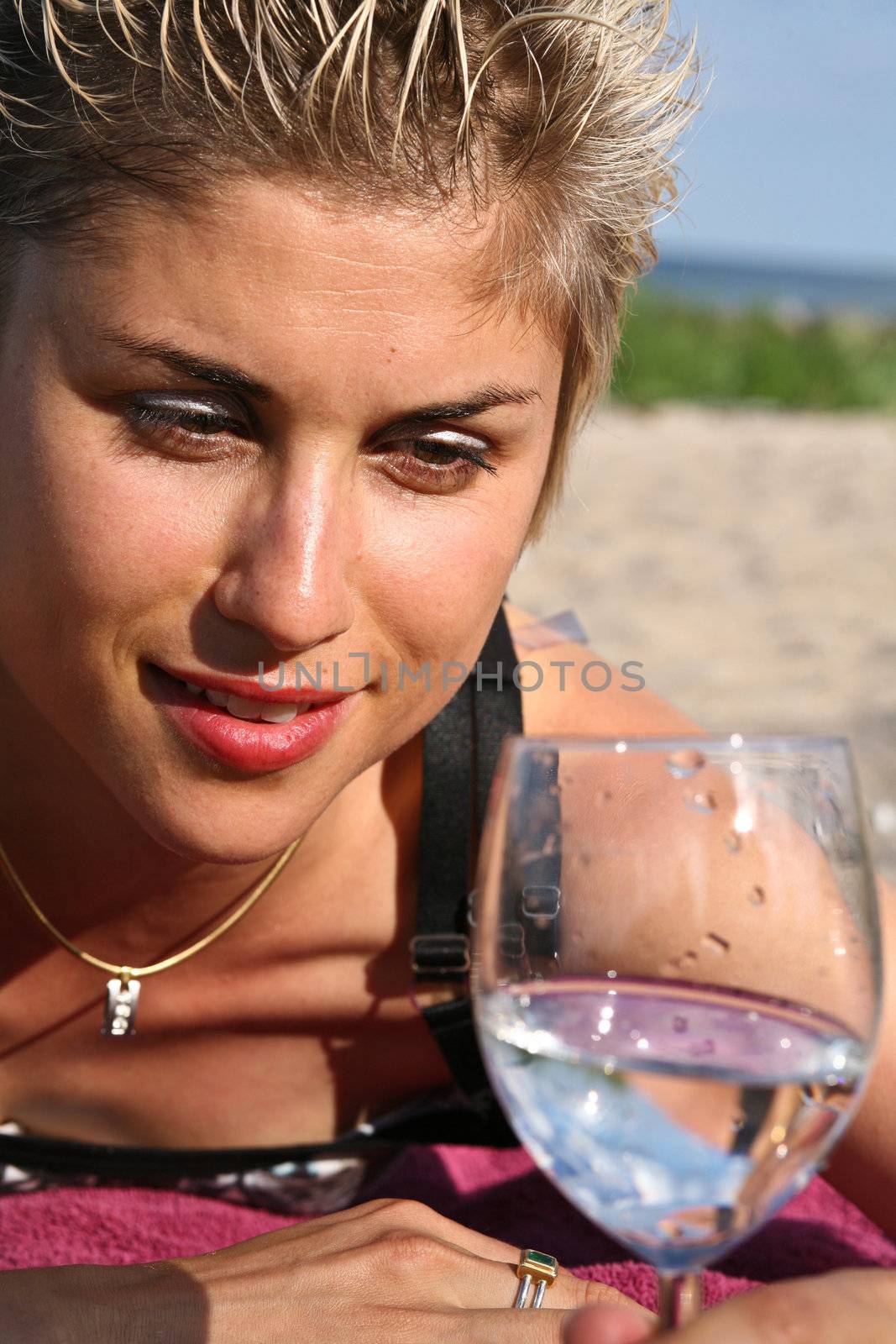 Cute blond girl playing with water in the summer in Denmark