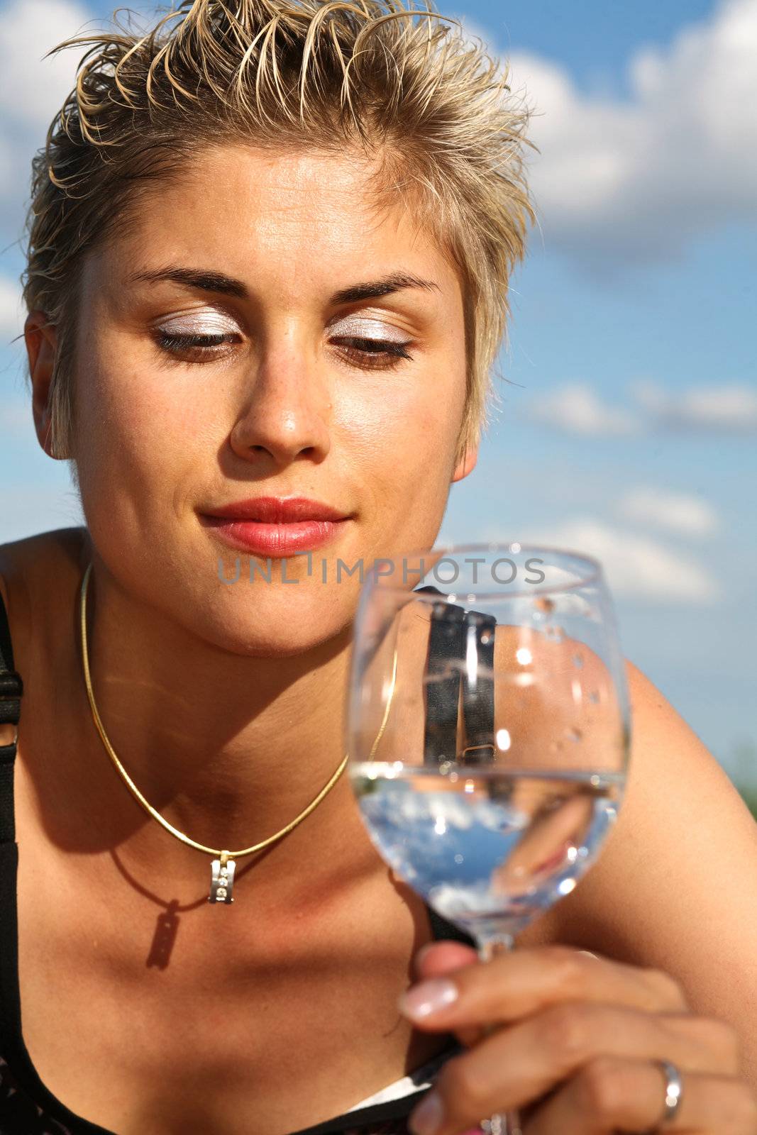 Cute blond girl playing with water in the summer in Denmark