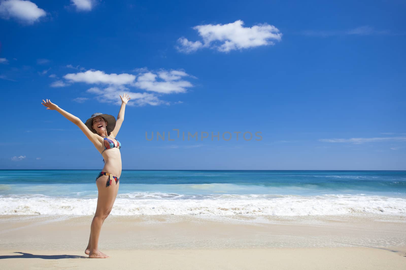 Beautiful young woman enjoying the summer in a tropical beach