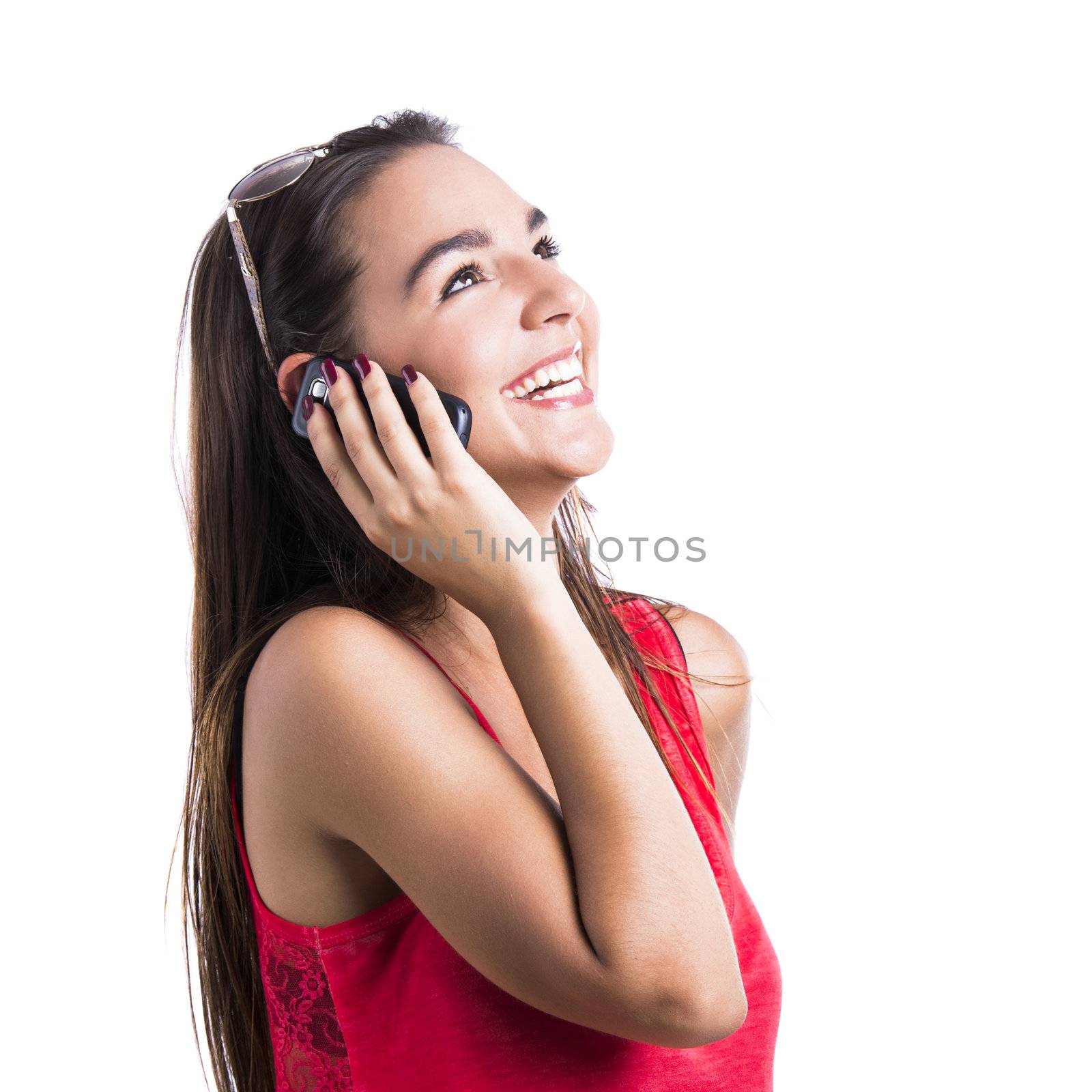 Beautiful woman talking at cell phone, isolated over white background