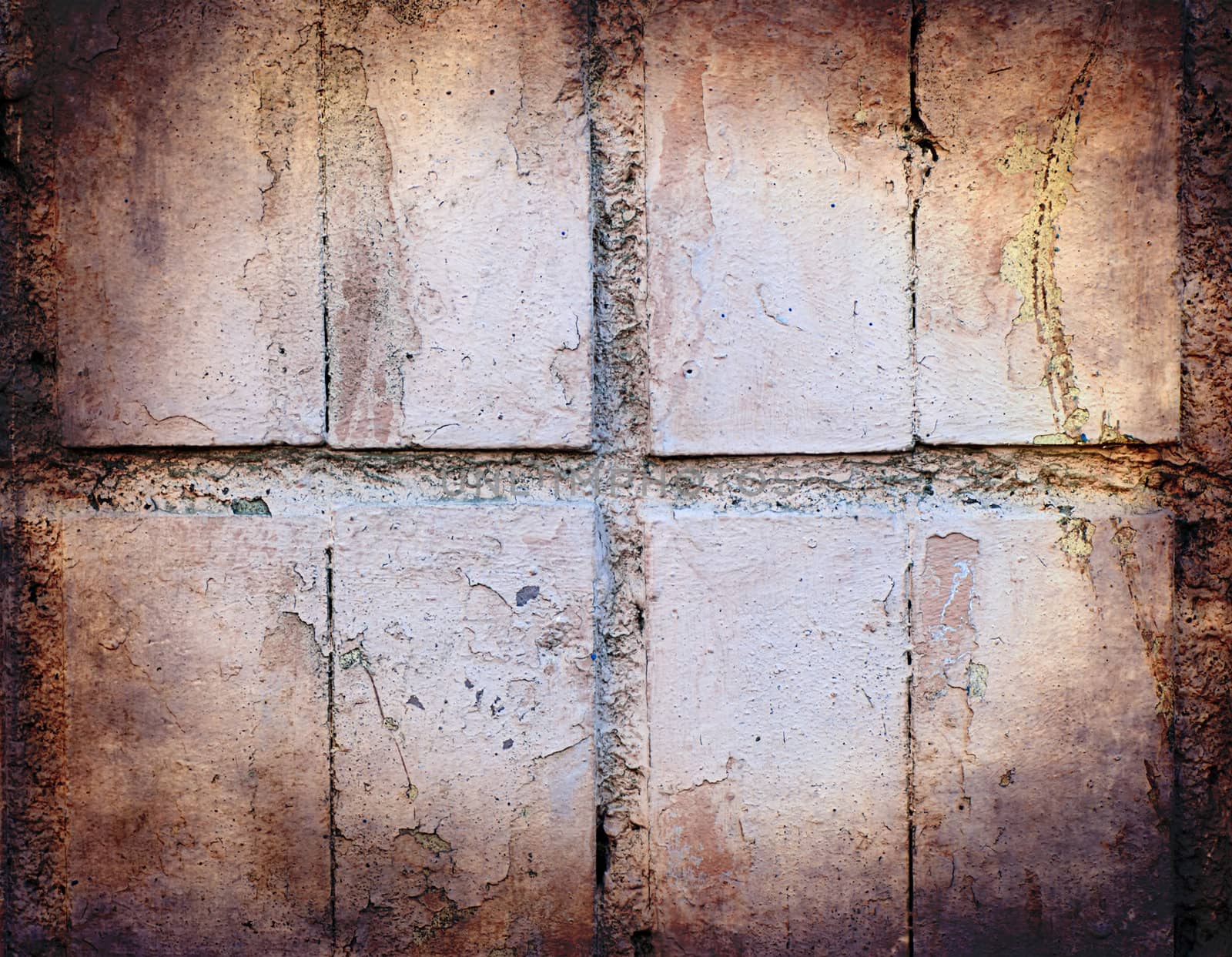 Grunge texture of pastel colour broken tiles on old wall