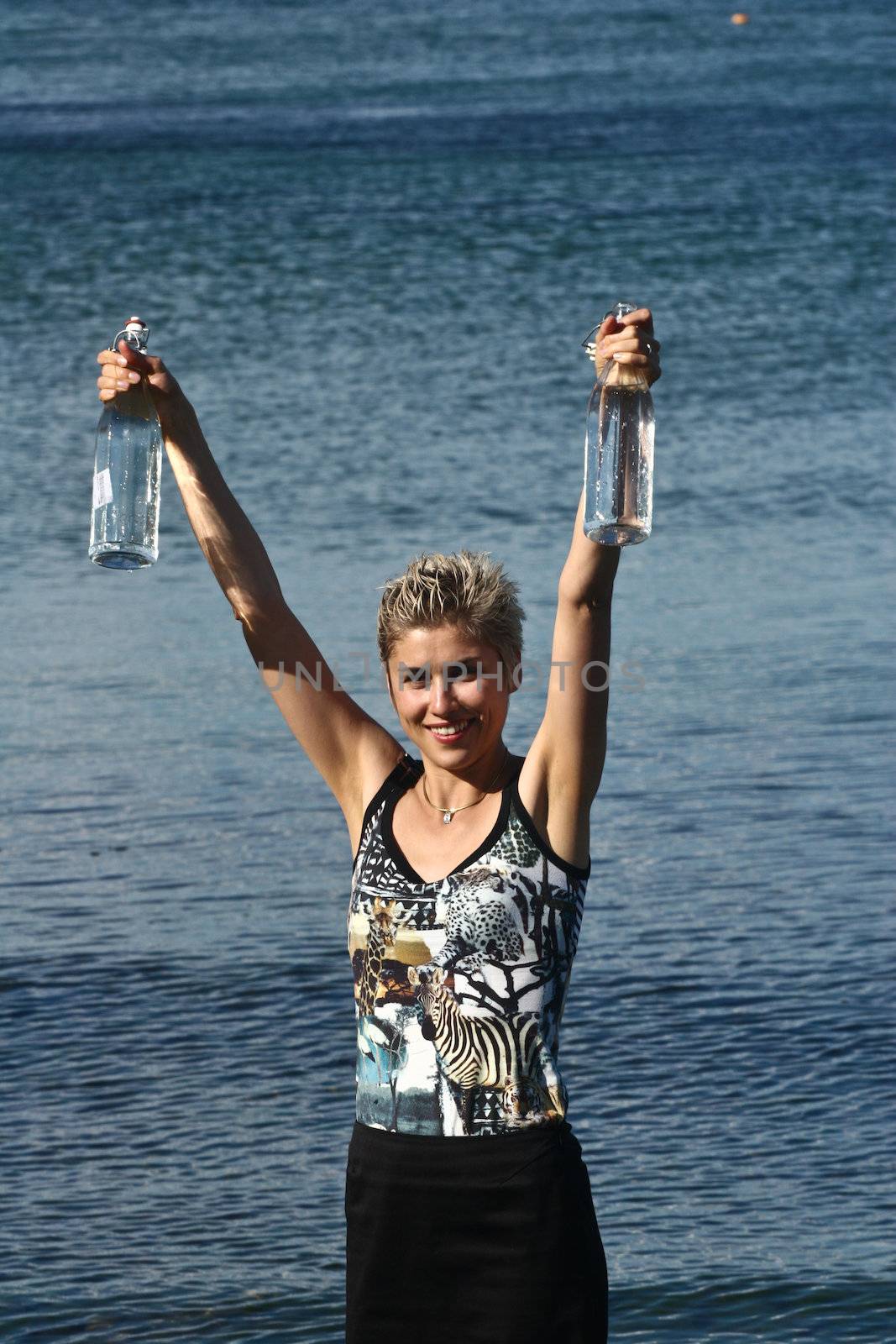 Cute blond girl playing with water in the summer in Denmark