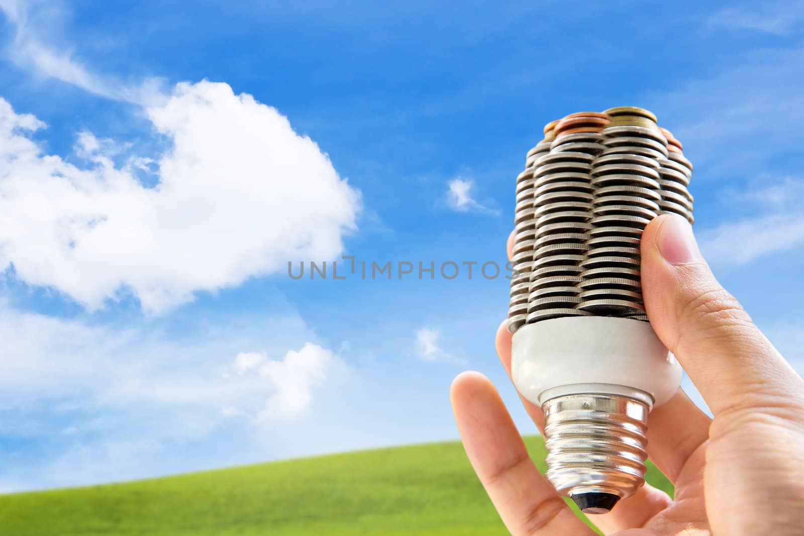 hand holding coin light bulb,energy concept