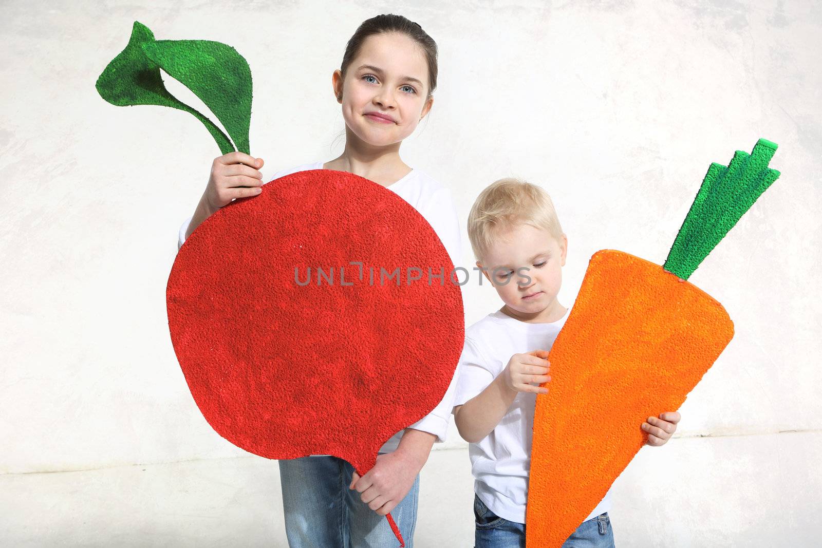 Brother and sister posing with painted carrot and beet by robert_przybysz