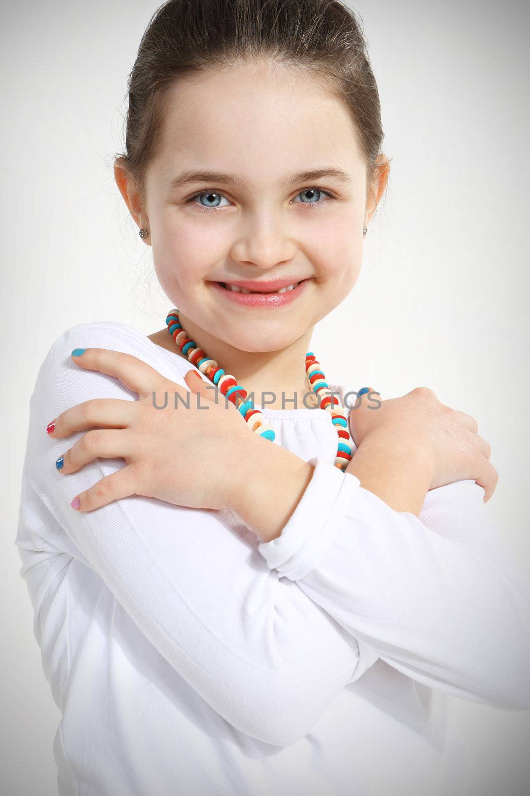 Portrait of smiling little girl with crossed arms by robert_przybysz