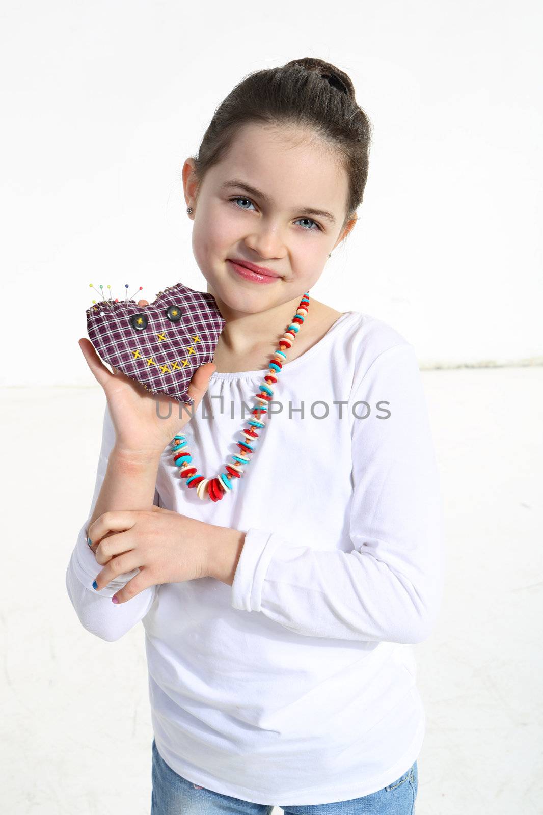 Girl posing with handmade toy isolated on white