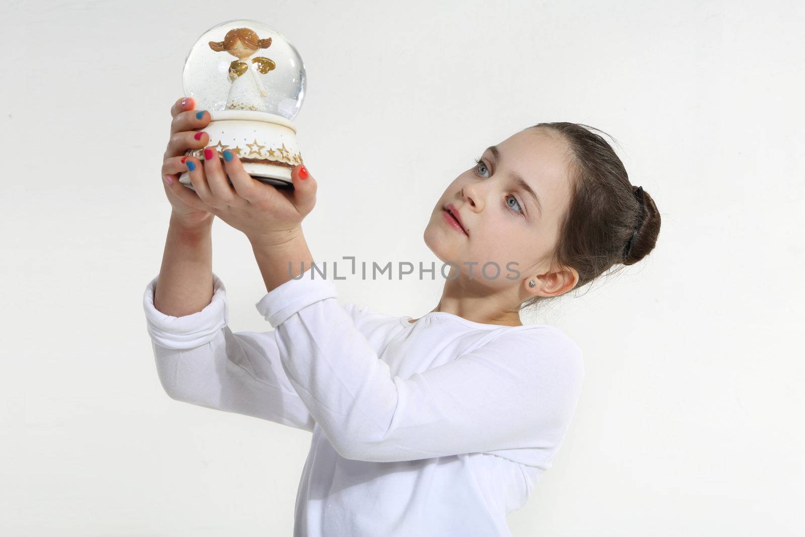 Little girl holding glass figurine by robert_przybysz