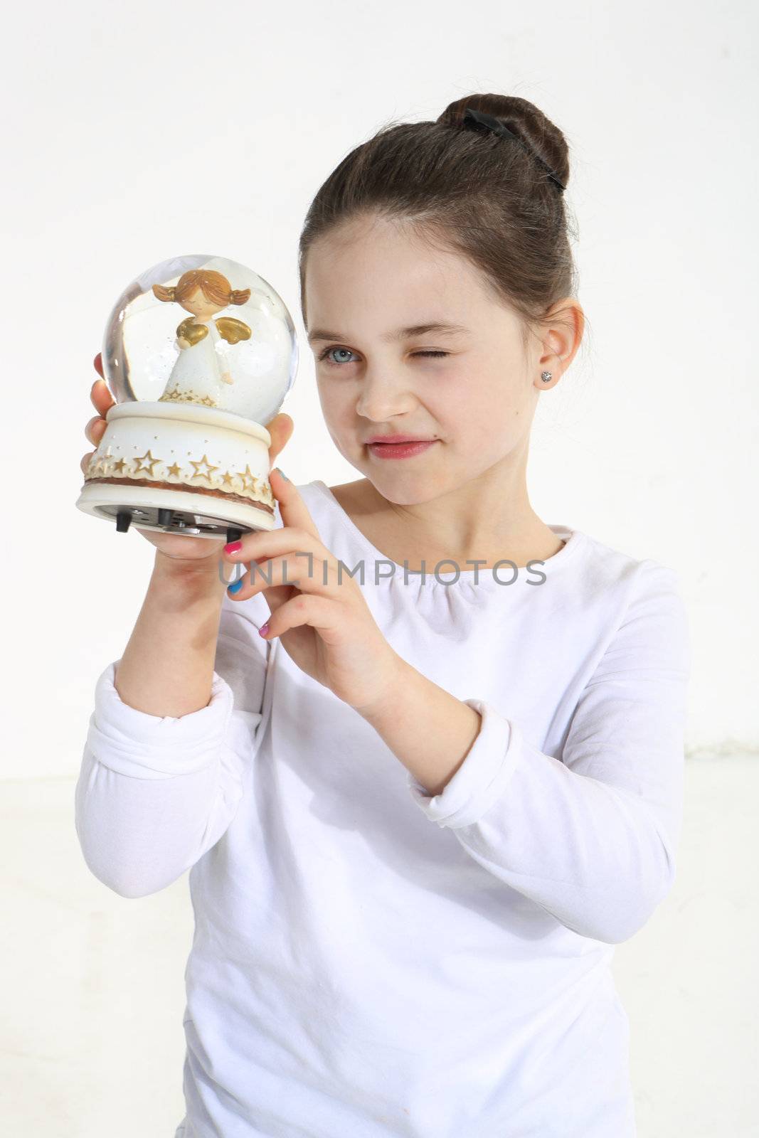 Little girl holding glass figurine