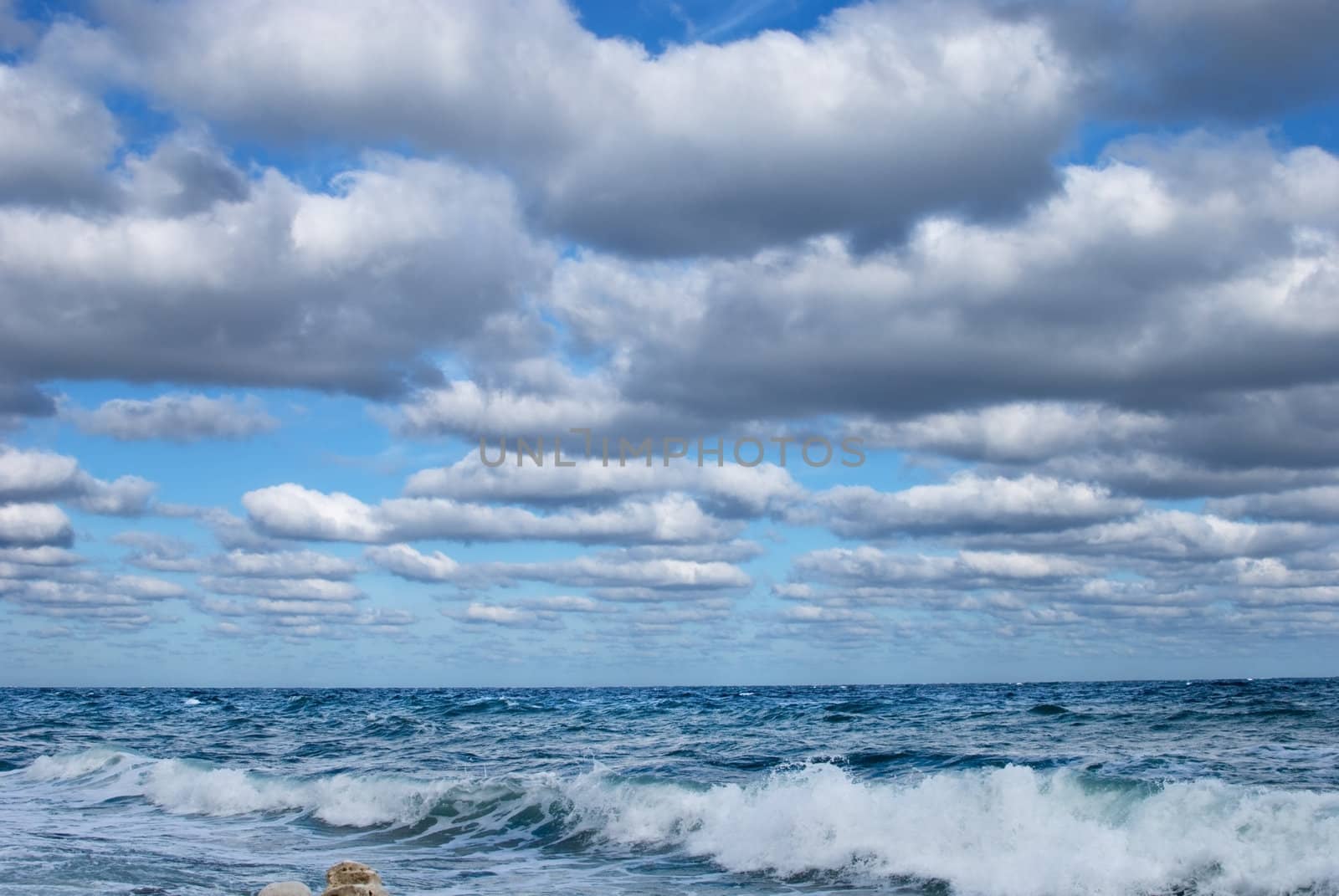 gorgeous flock of clouds flying over the stormy sea