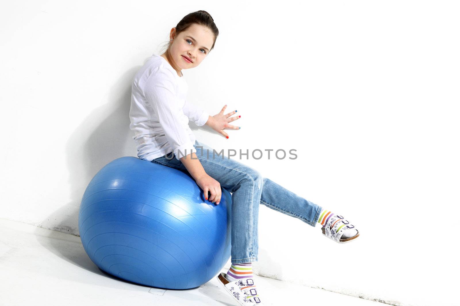 Little girl posing with a rubber ball