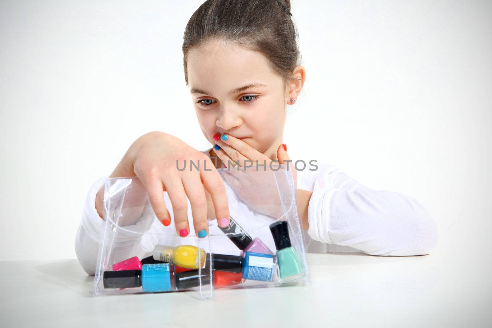 Little girl and nail polishes