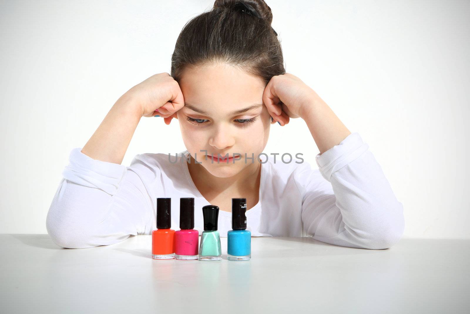 Little girl and nail polishes