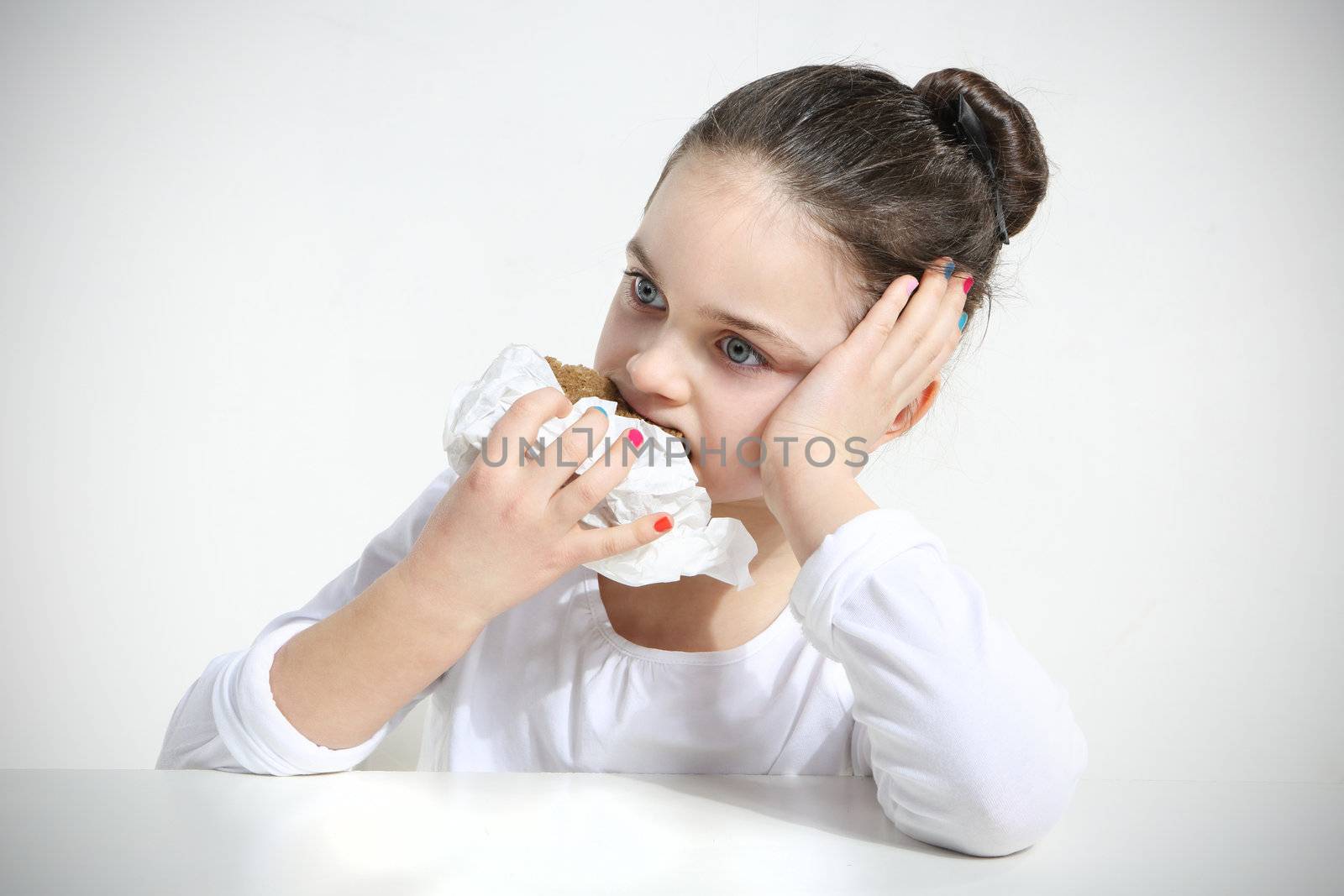 Beautiful girl eating bread isolated on white
