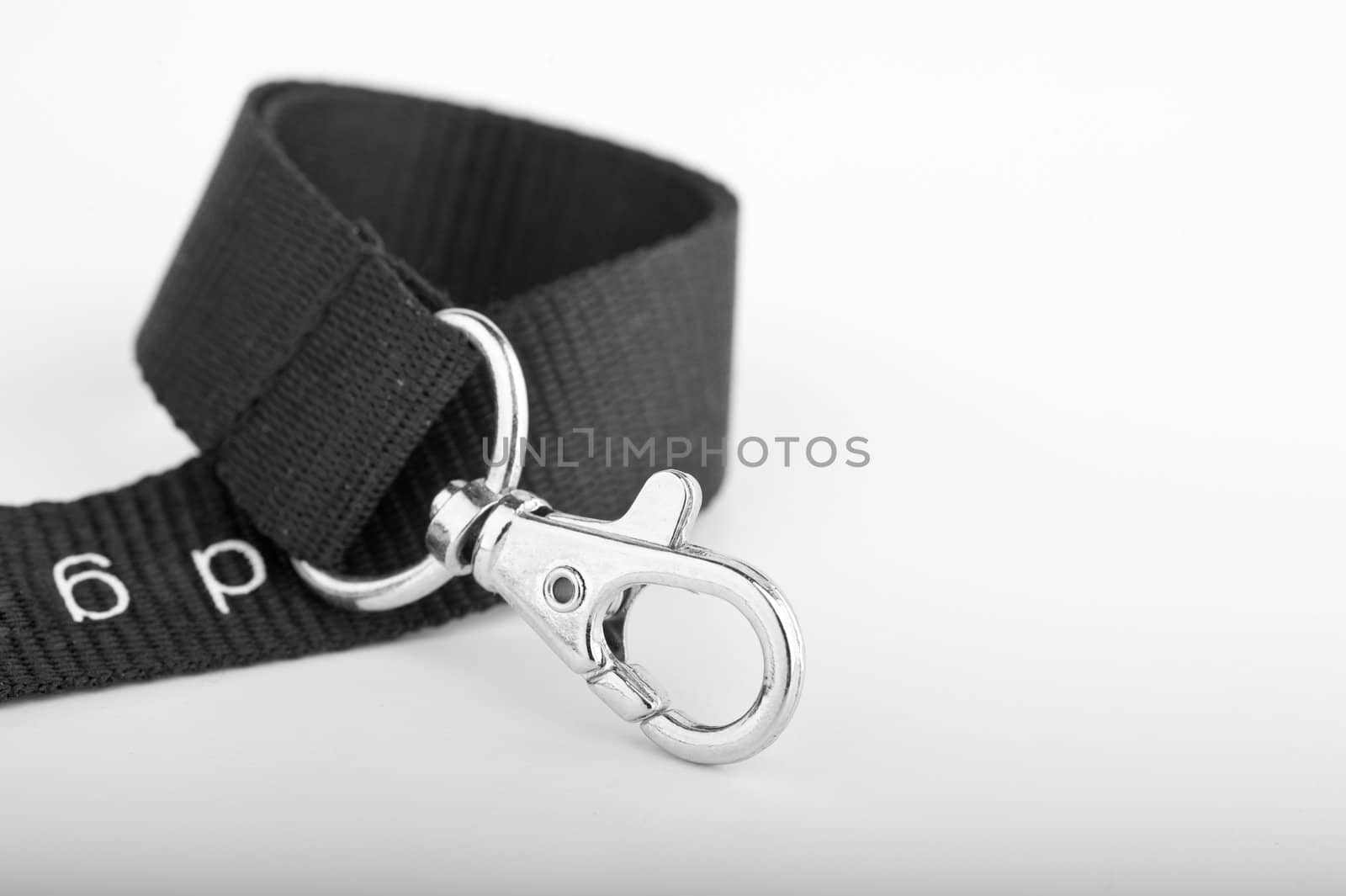 Chrome Key ring clip on curled up black lanyard on gradient background