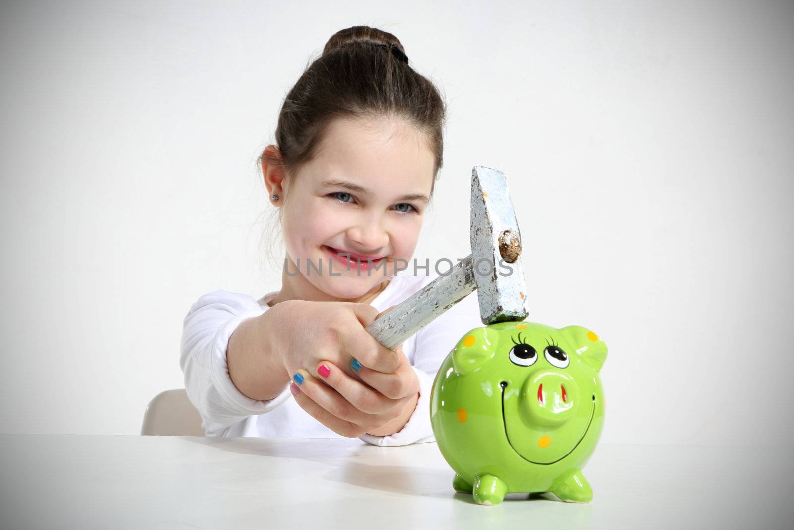 Little girl breaking piggy bank isolated on white by robert_przybysz