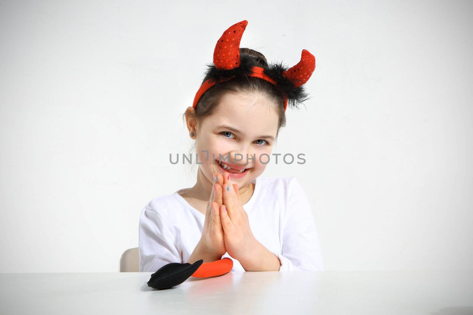 Little girl dressed as pretty imp in studio by robert_przybysz