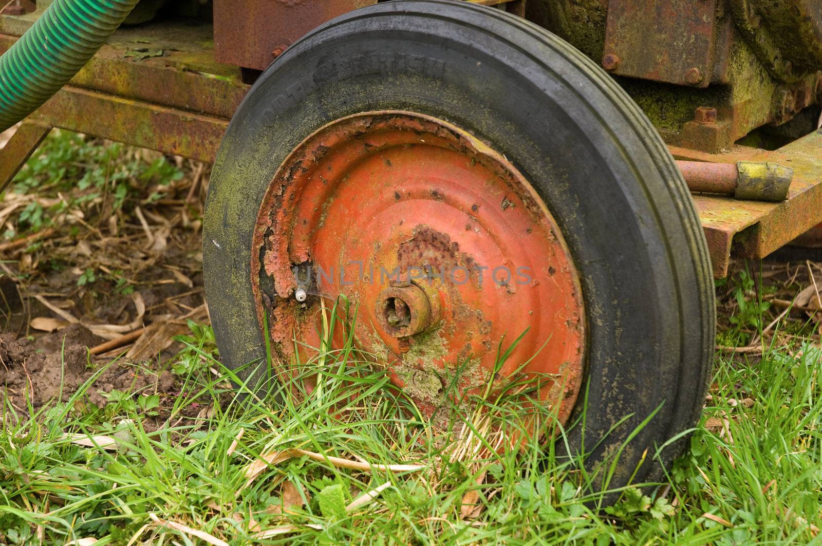 Old red wheel on mobile waterpump