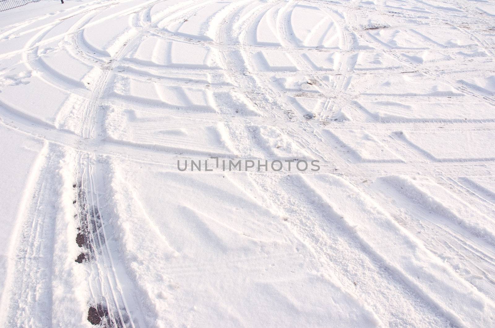 Car tire track in fresh light snow