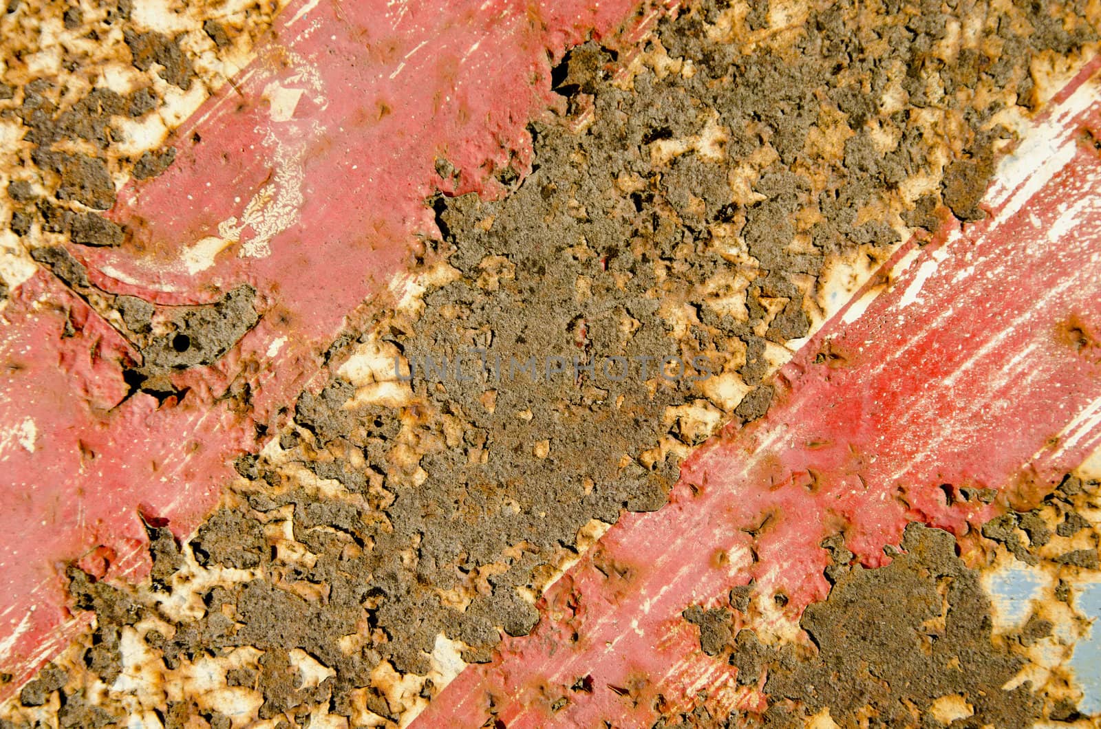 Rusty red painted metal road sign fragment. Interesting background.