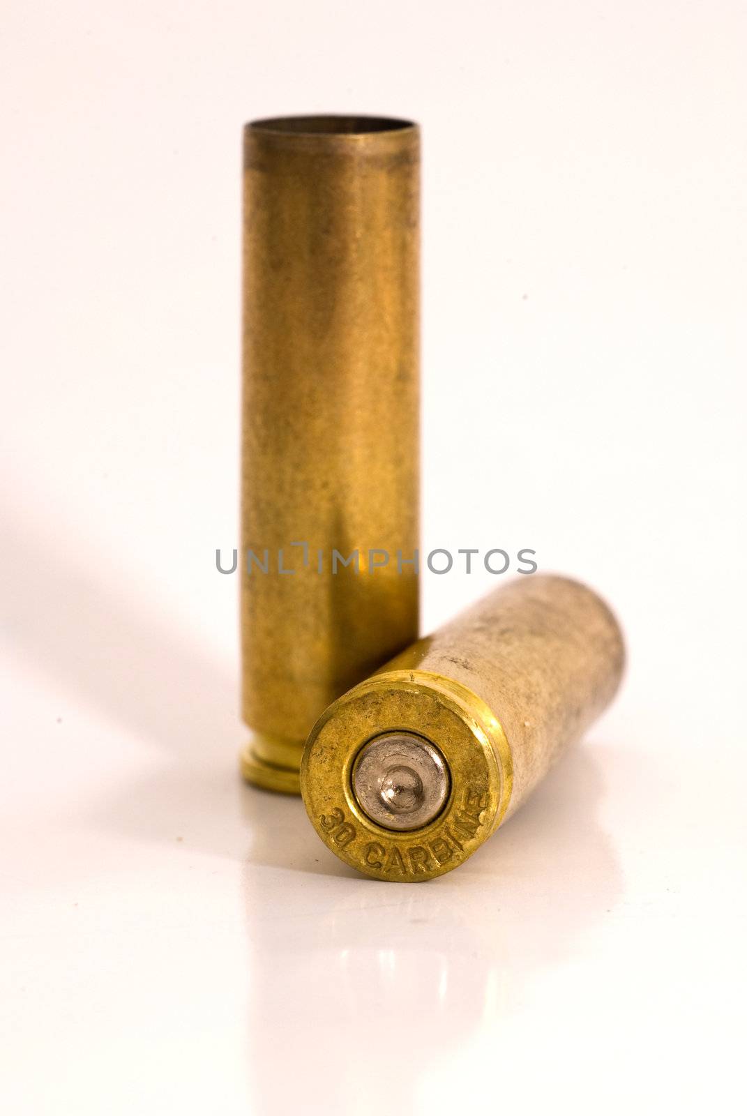 Two dirty .30 M1 Carbine shell casings