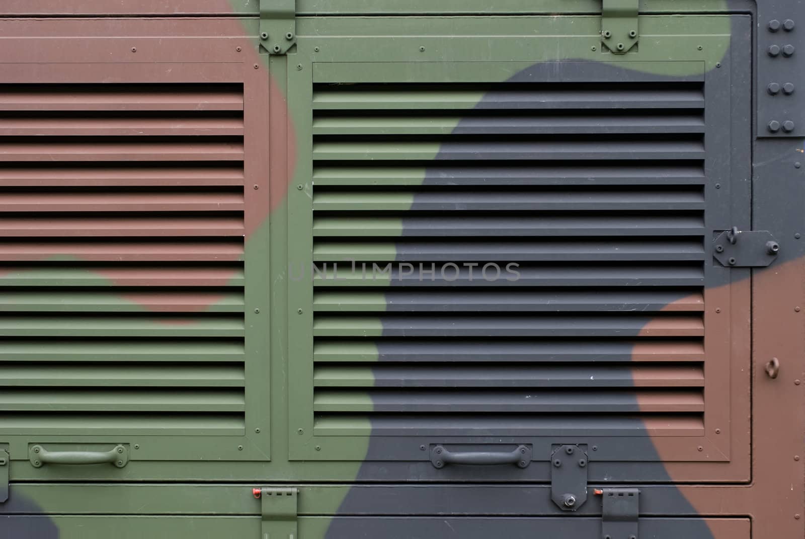 Ventilation grille on camouflaged aluminum army shelter