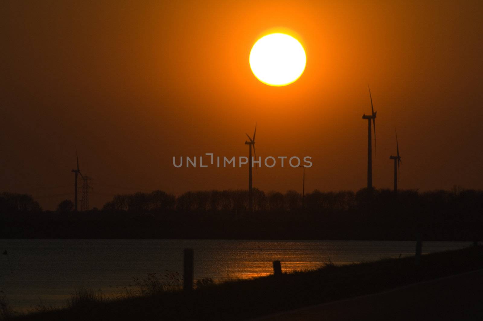 Wind turbines and setting sun