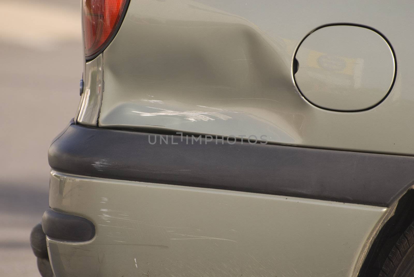 A dent in the right rear quarter of a european car