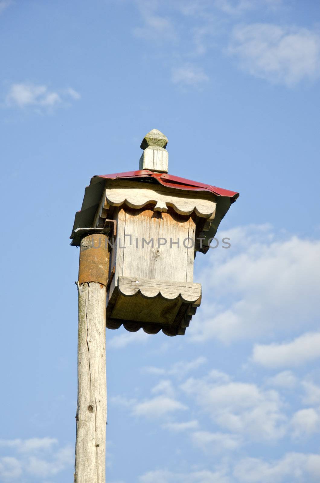 original ornamental wooden nesting box on sky background