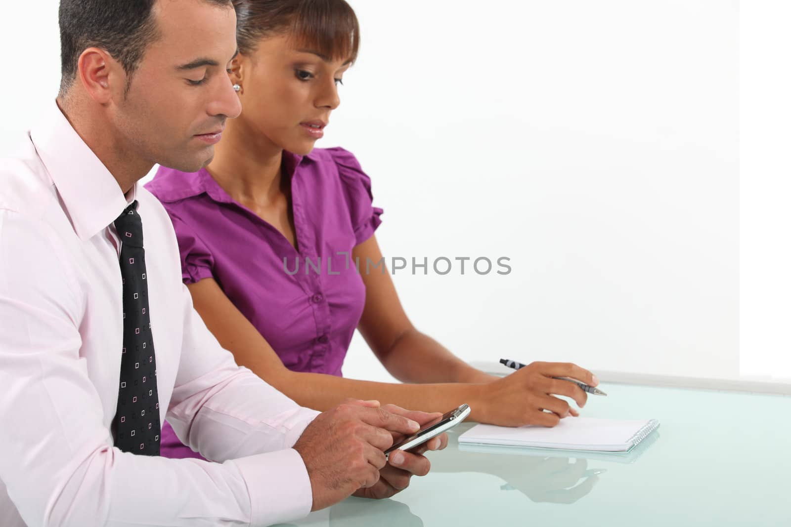 Business couple going over accounts by phovoir