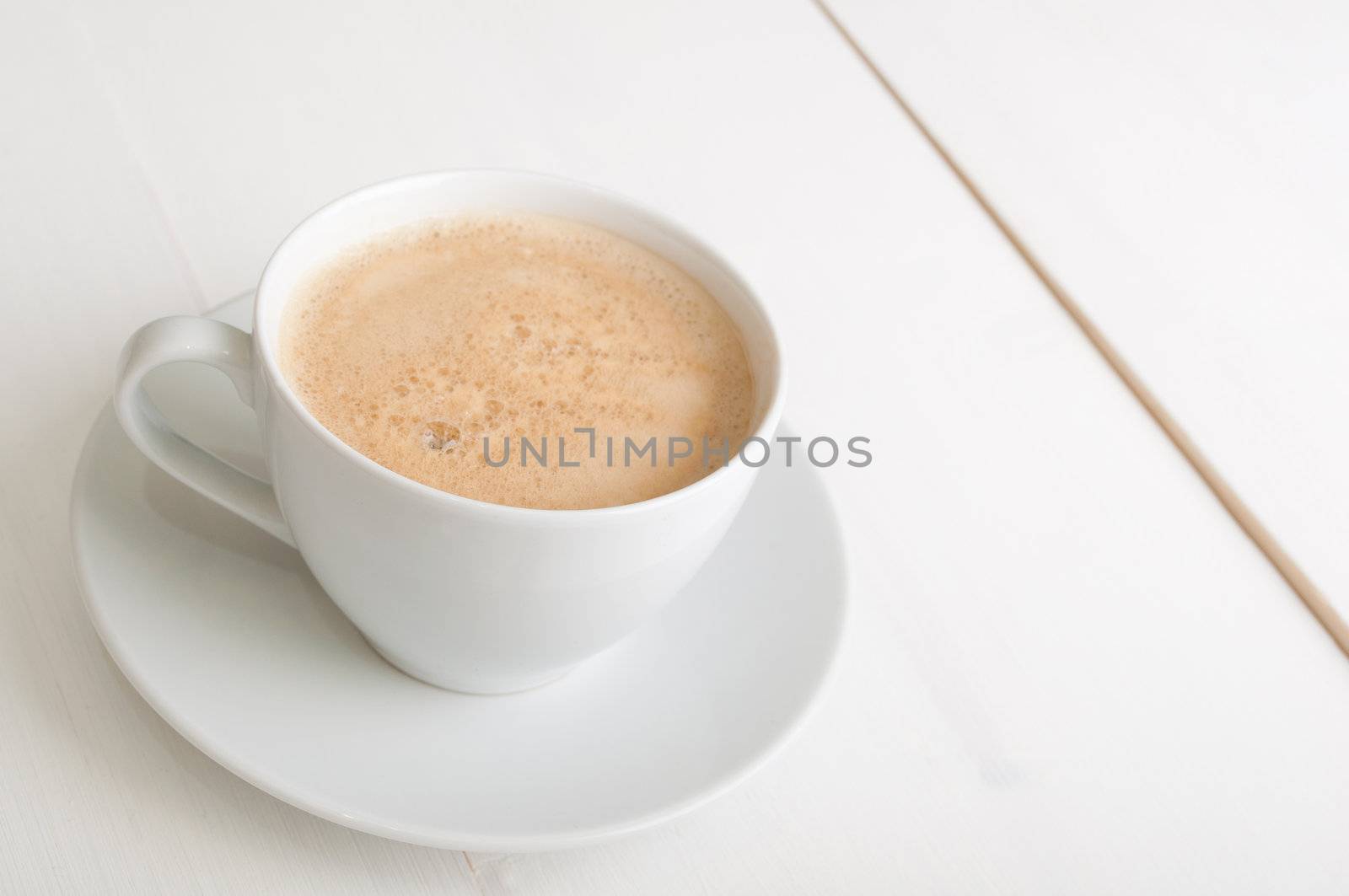 Creamy Espresso Coffee in White Cup on Table