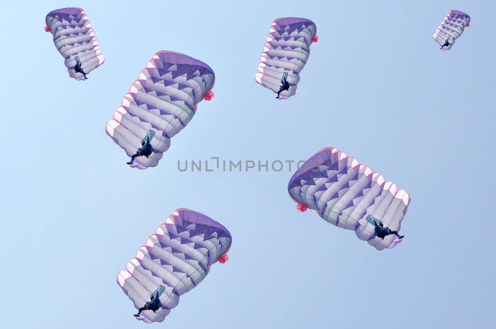 Many parachutes over a blue sky background