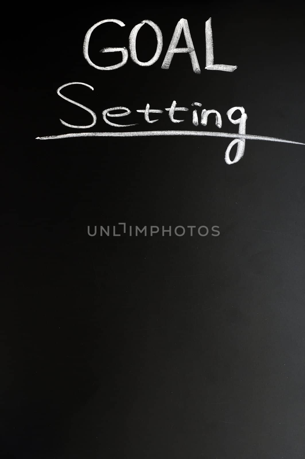 Goal setting written with chalk on a blackboard