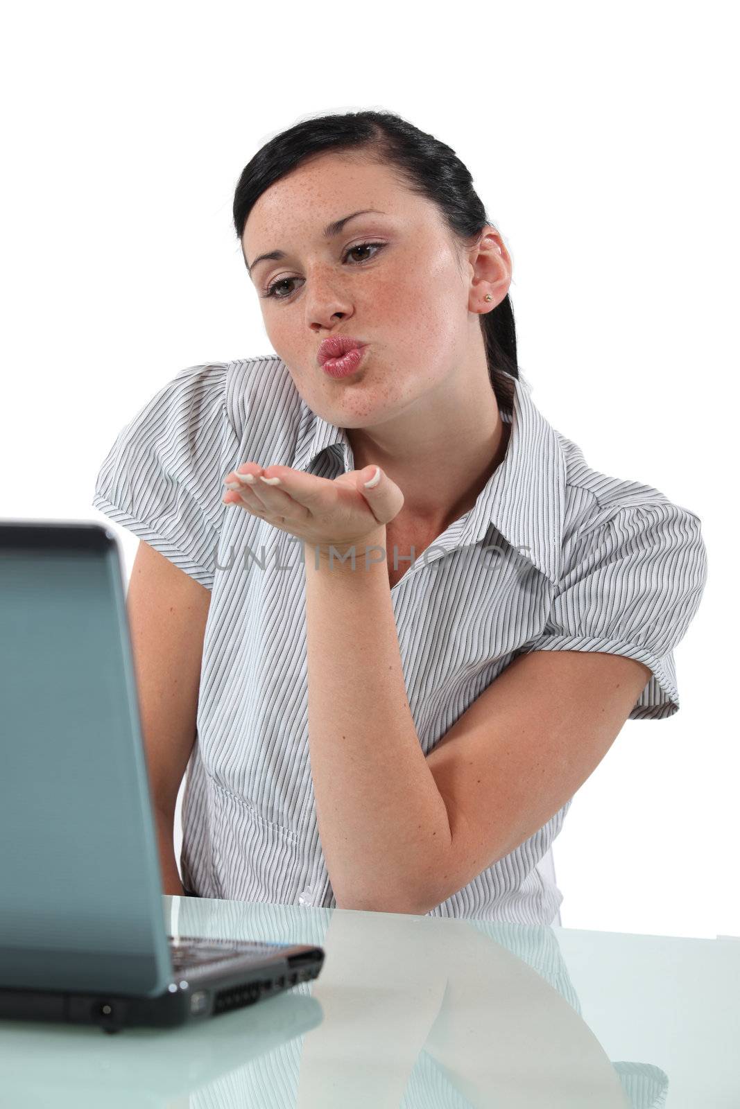 Young woman sending kisses through webcam