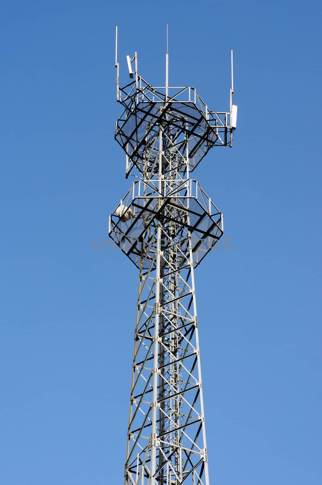 Mobile phone base station and antenna tower against the blue sky