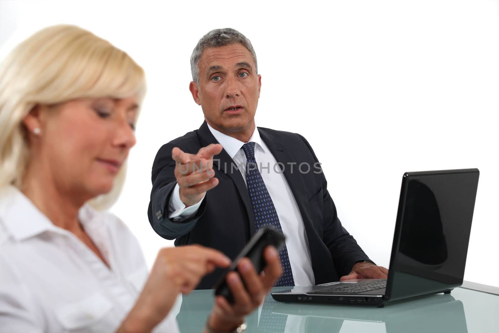 businessman and businesswoman having a discussion by phovoir