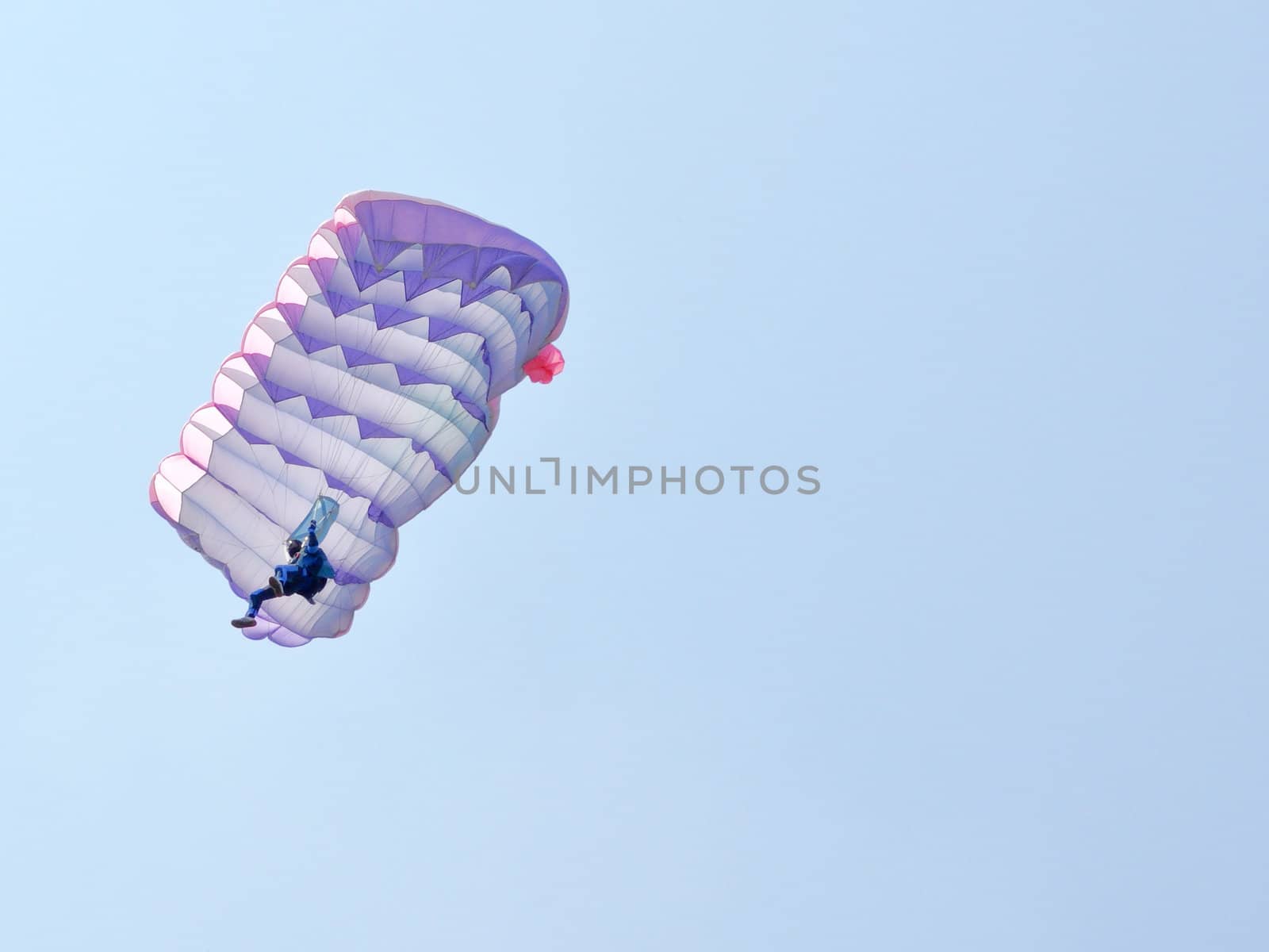 A parachute over a blue sky background