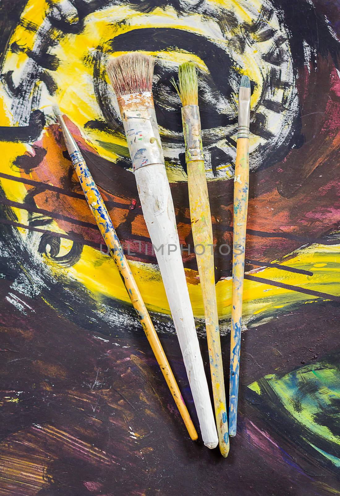Set of paint brushes on jar, on oil painting