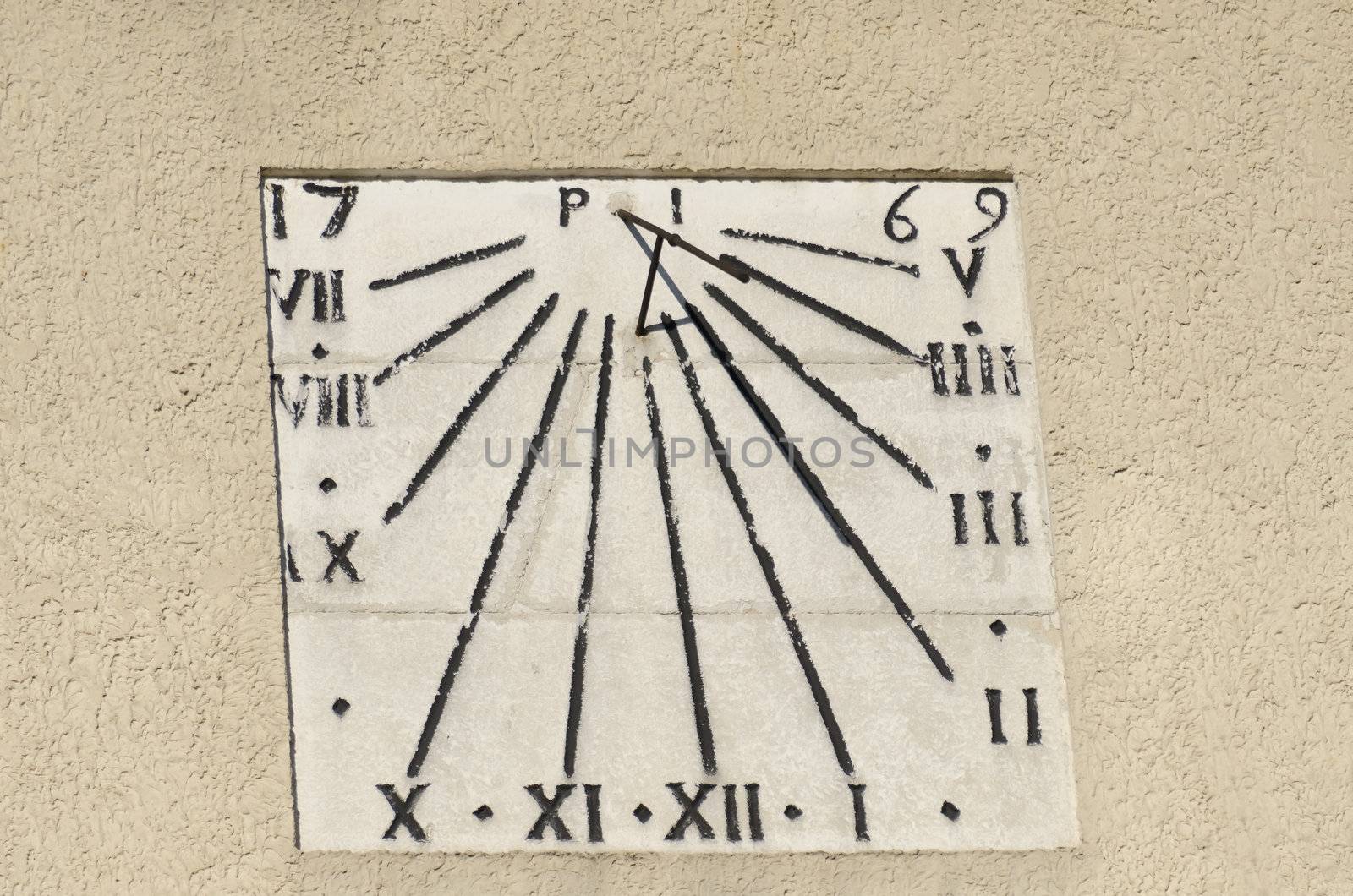 old sundial on a wall