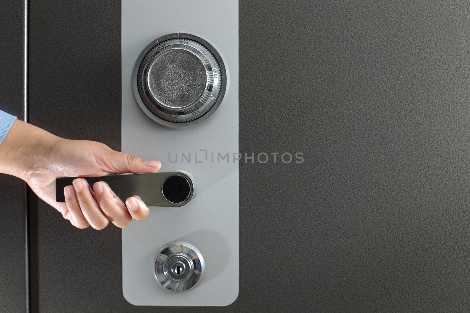 Hand opening a safe by photosoup