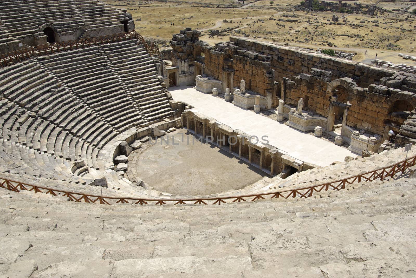 Amphitheater in ancient city Hierapolis. Pamukkale, Turkey. Midd by borodaev