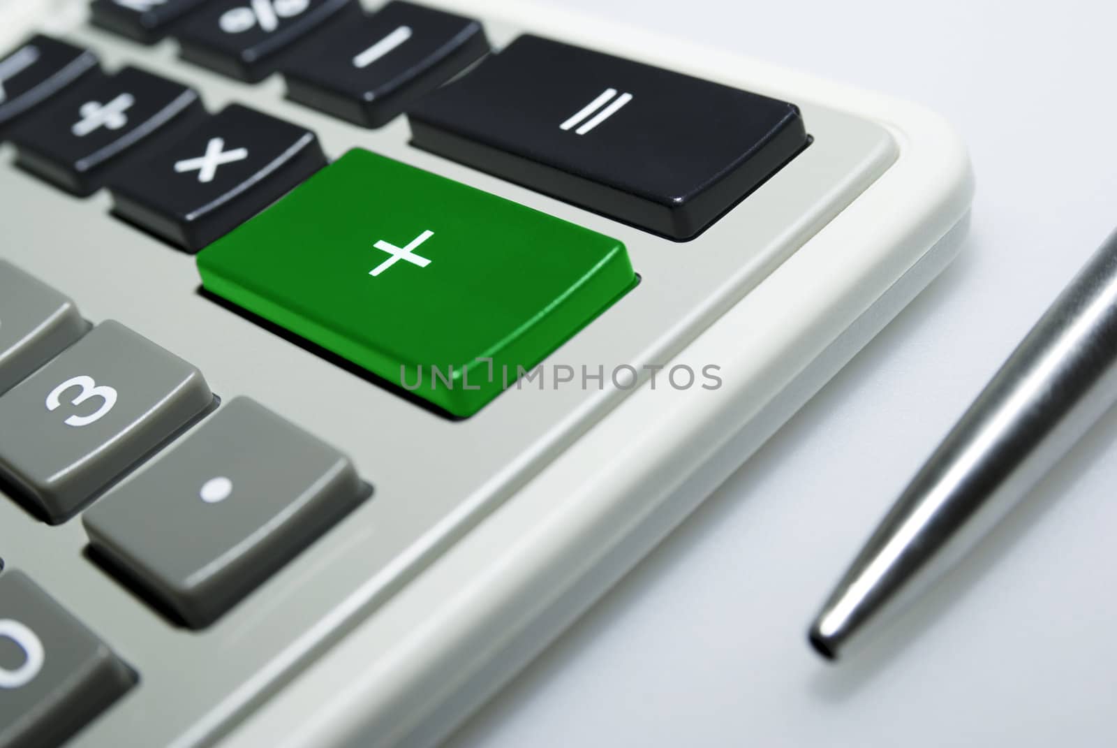 Calculator and pen on white background.