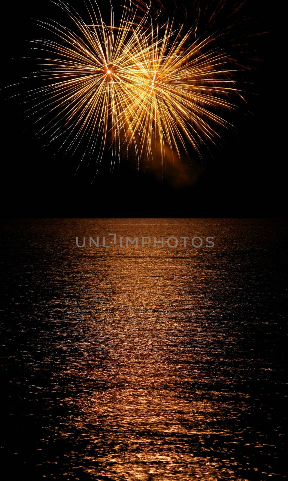 Long Exposure of Fireworks Reflecting on Calm Rippling Water