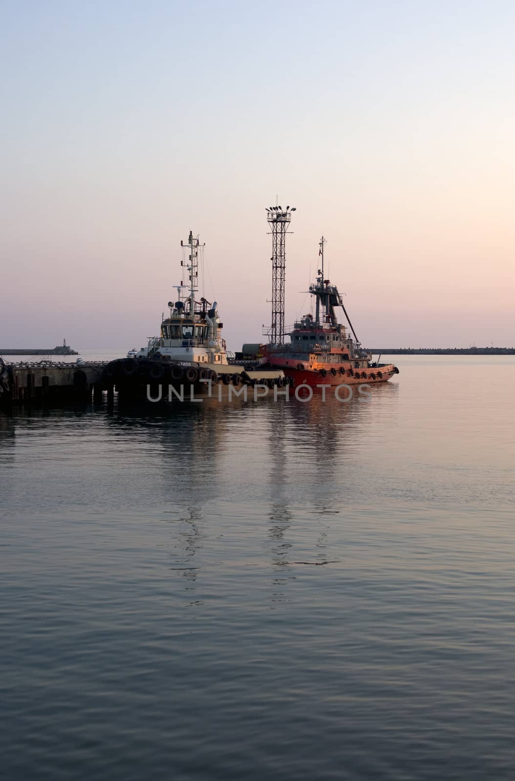 Ships in Tuapse seaport on sunset. Black Sea, near Sochi, Russia.